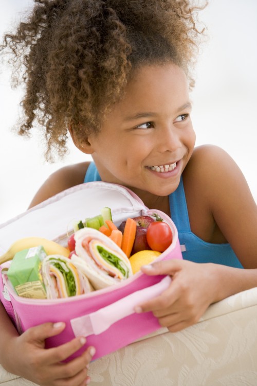 young girl holding teeth-friendly lunch box | Doctor Andy