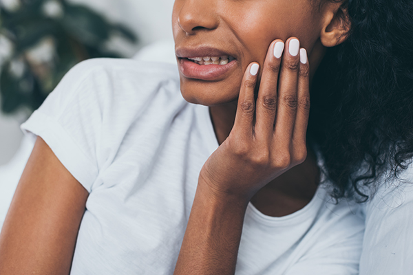 A woman with TMJ pain in need of braces for treatment